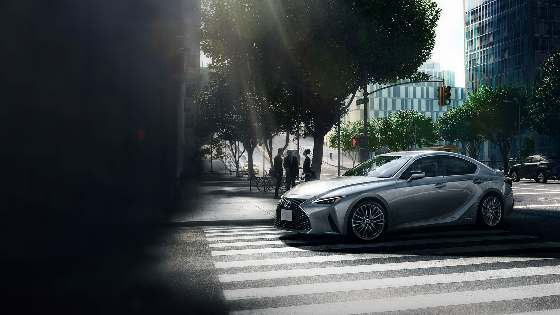 Silver Lexus IS being driven in a city.